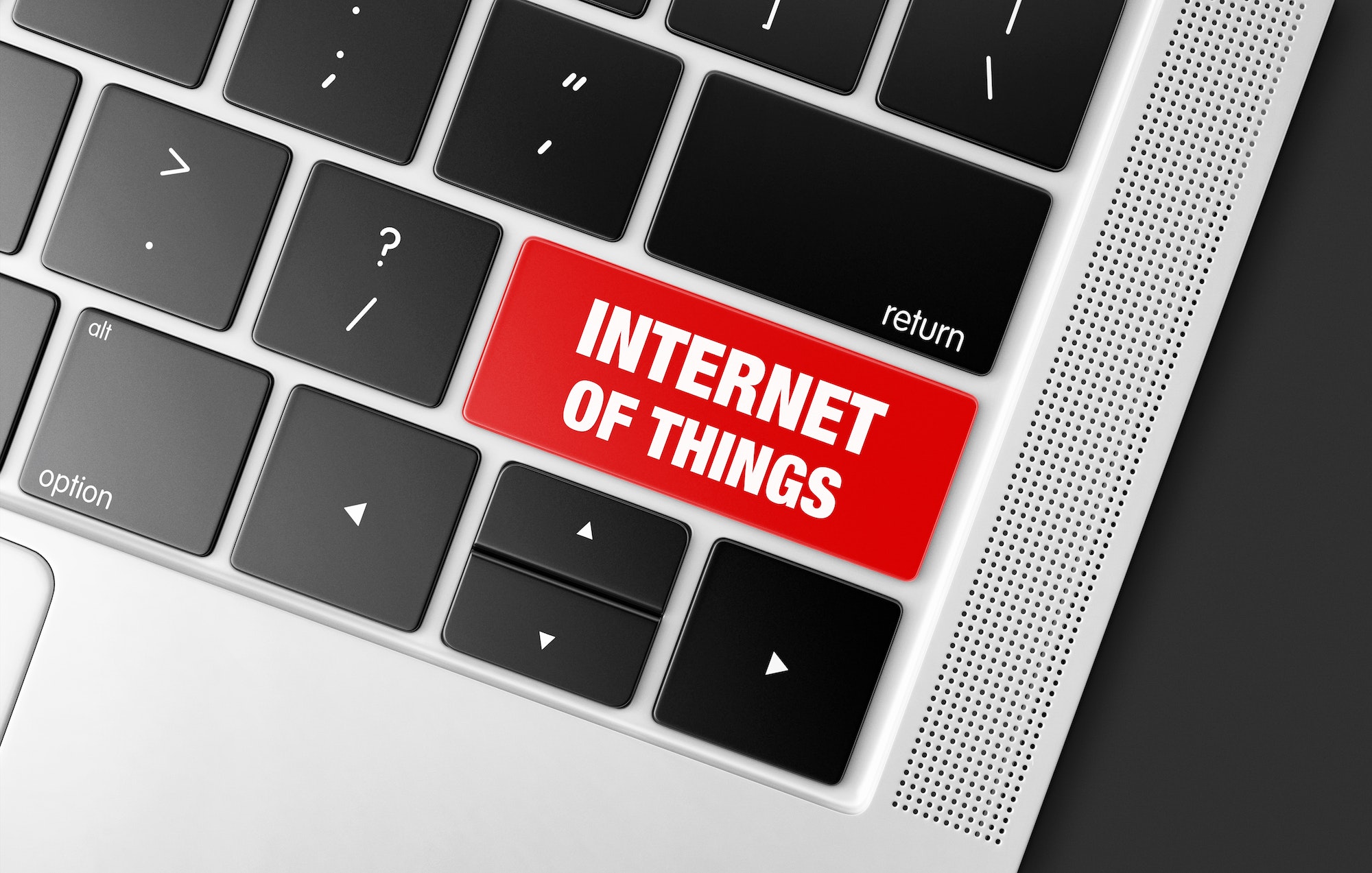 Red Internet of things key on a black computer keyboard, concept picture of modern technology trends