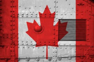 Canada flag depicted on side part of military armored tank close up