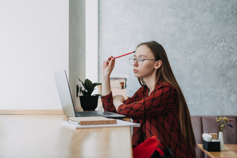 College students mental health. Sad and frustrated teenager student girl sitting with laptop