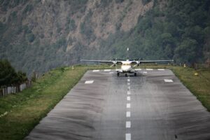 white and yellow plane on gray asphalt road during daytime