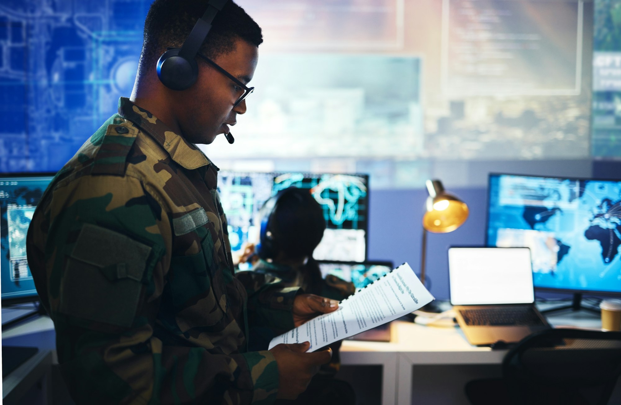 Control room, military documents and people on computer for surveillance, tracking operation and na