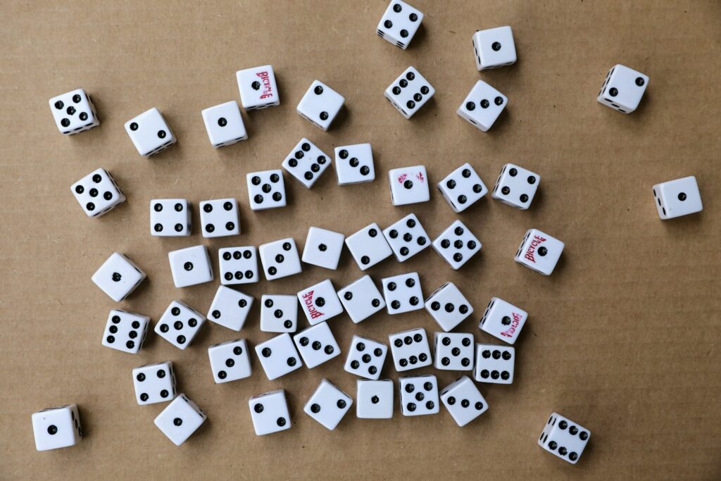 white and black dice on brown wooden table