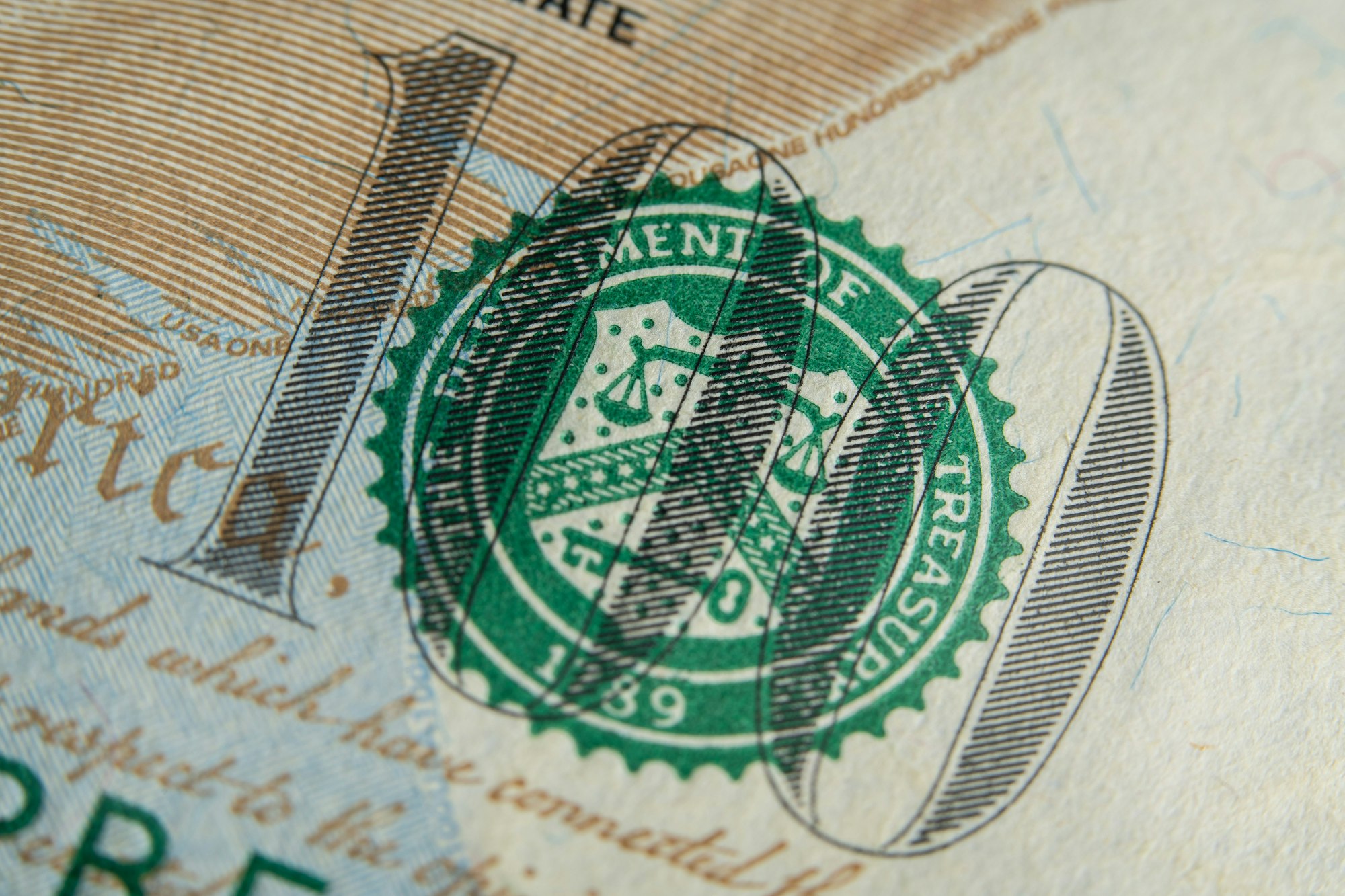 A close-up of the US Treasury Department seal on a US $100 bill