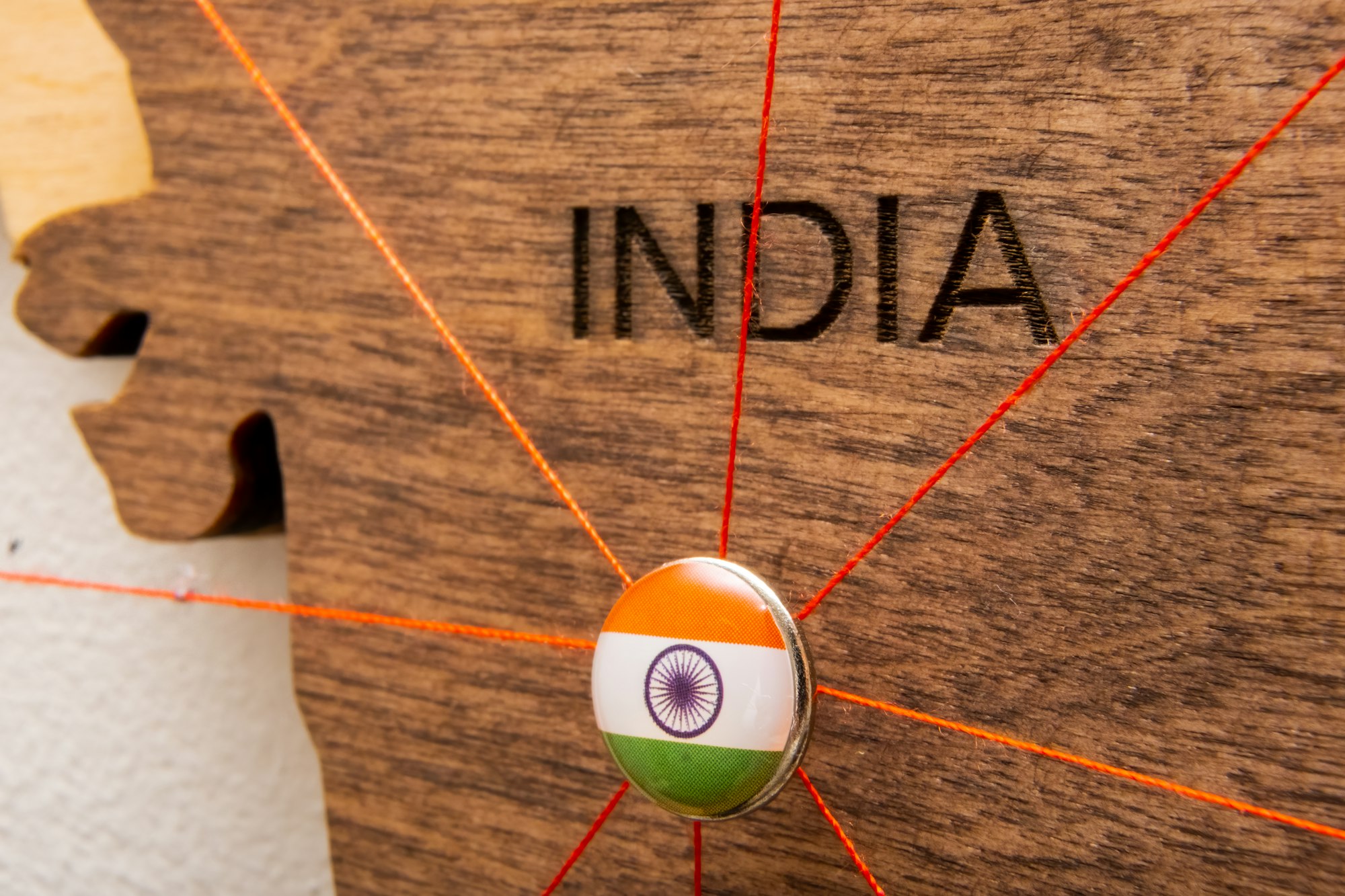 India flag pins and red thread for traveling and planning trip.