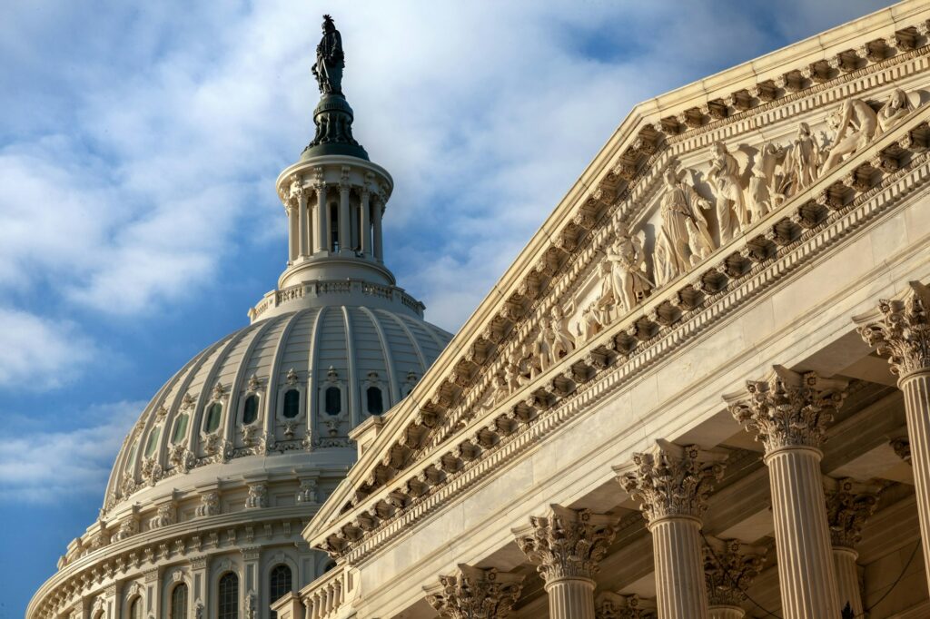 U.S. Capitol closeup of base relief and dome with Liberty statue early morning