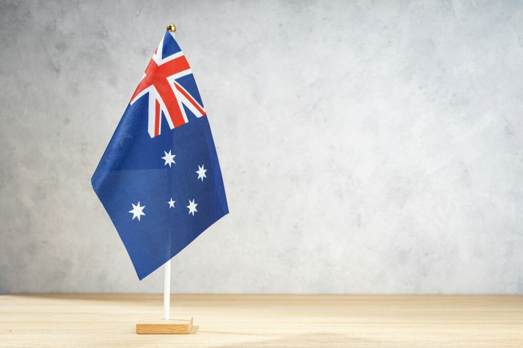 Australian table flag on white textured wall