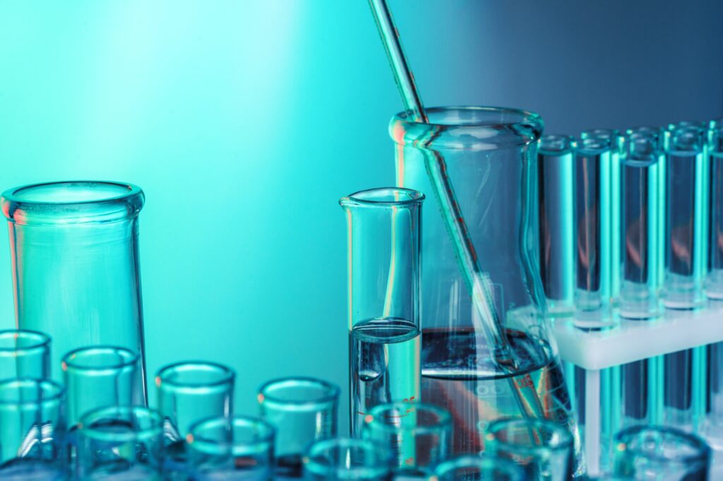 Laboratory chemistry glassware on green toned background