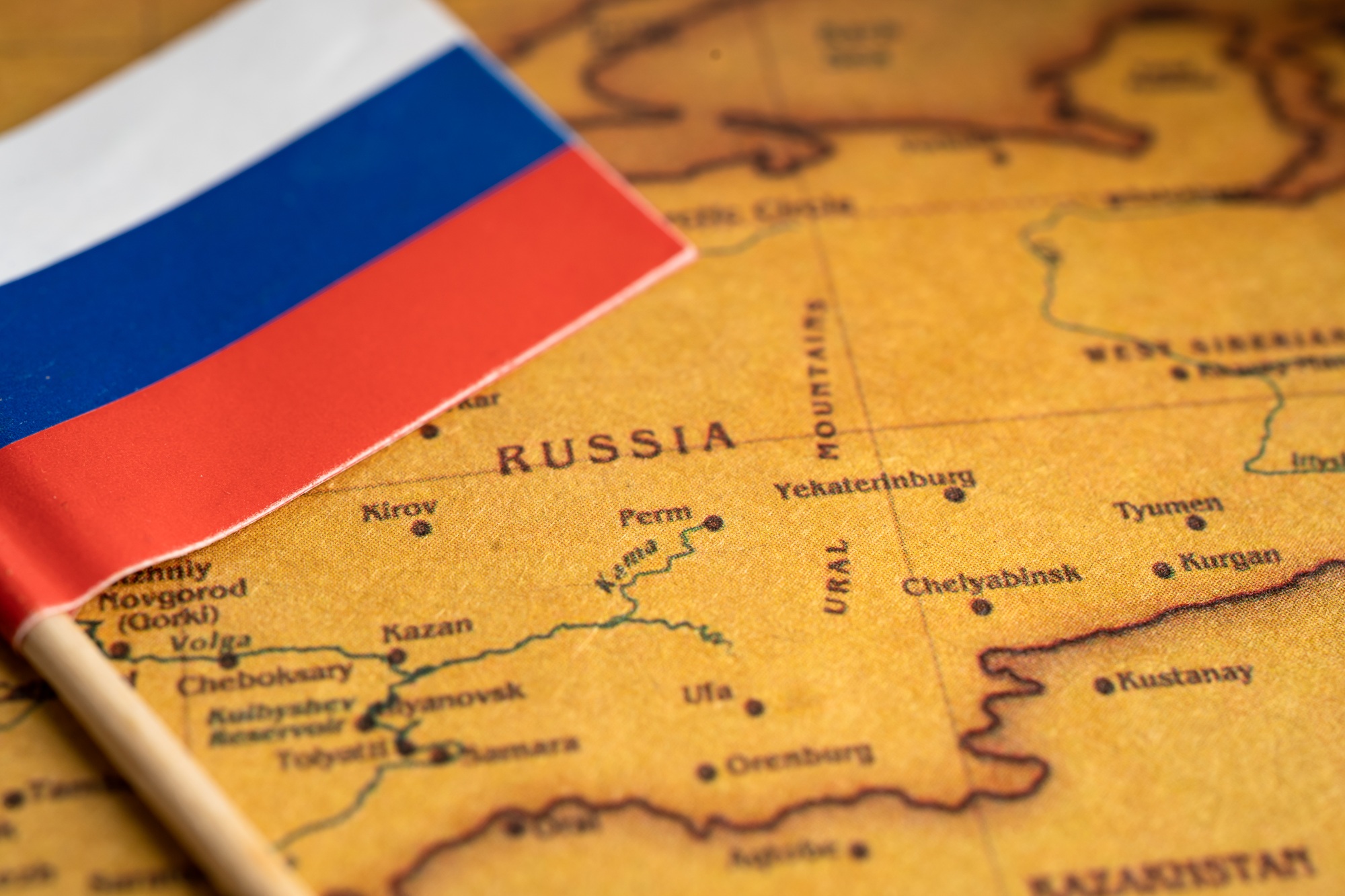 Bangkok, Thailand - February 1, 2022 Russia flag on vintage world map background.