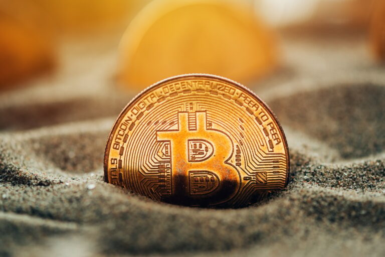Bitcoins in sand