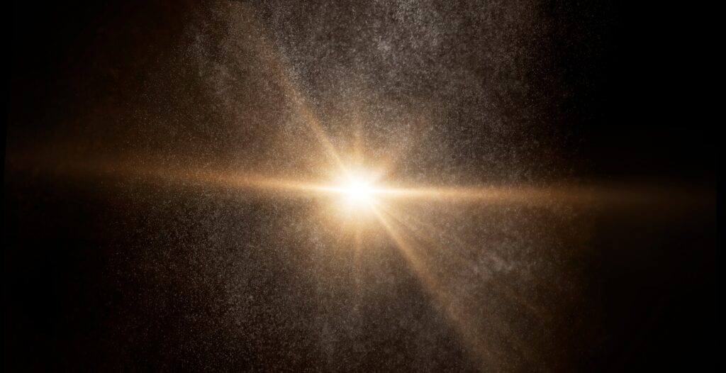 Bright star shining through cosmic dust and particles creating a golden glow