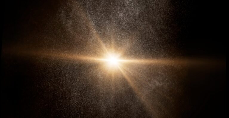 Bright star shining through cosmic dust and particles creating a golden glow