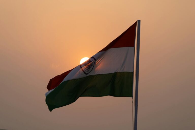 The Indian national flag waves majestically against a sunset backdrop, symbolizing patriotism in Lucknow.