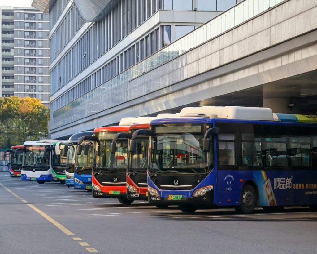 A line of buses parked next to each other