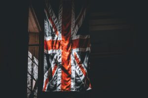 A dramatic portrayal of the Union Jack flag inside a dimly lit room.