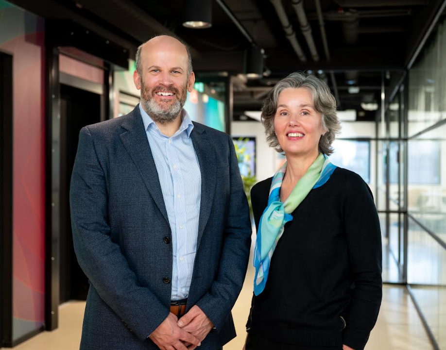 Neil Gillespie and Professor Barbara Terhal standing together inside the House of Quantum Delft.
