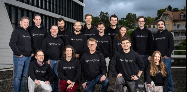 Enlightra team members standing together.