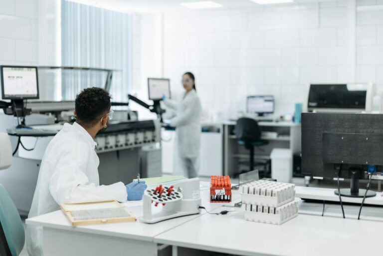 Scientists working with lab equipment, analyzing samples for research.