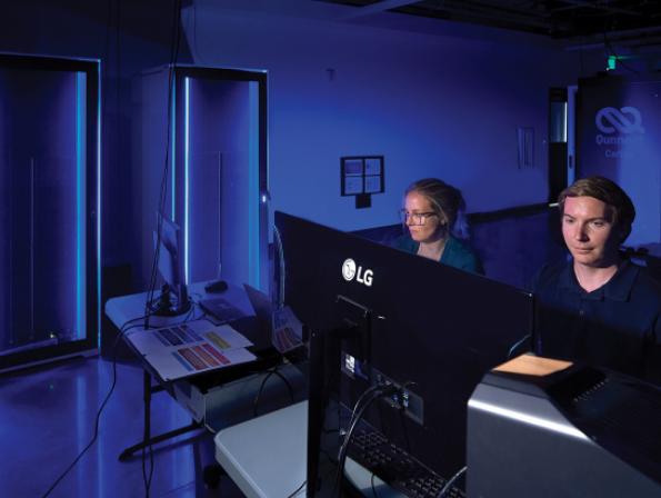 Catherine Hahola, assistant director of systems for Montana State University Information Technology, left, and Coltran Hophan-Nichols, director of systems and research computing, work with quantum computers in the QCORE facility. MSU photo by Kelly Gorham