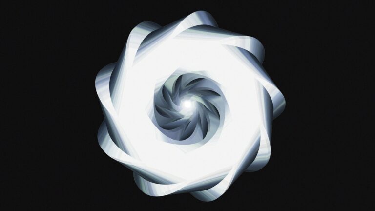 A luminous, spiraling design against black.