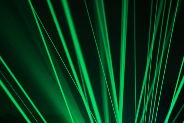 a green light is shining in the dark