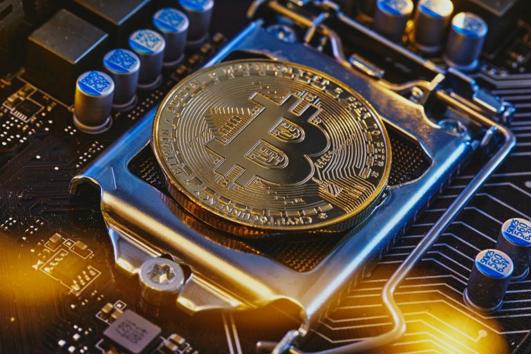 a bitcoin sitting on top of a computer motherboard