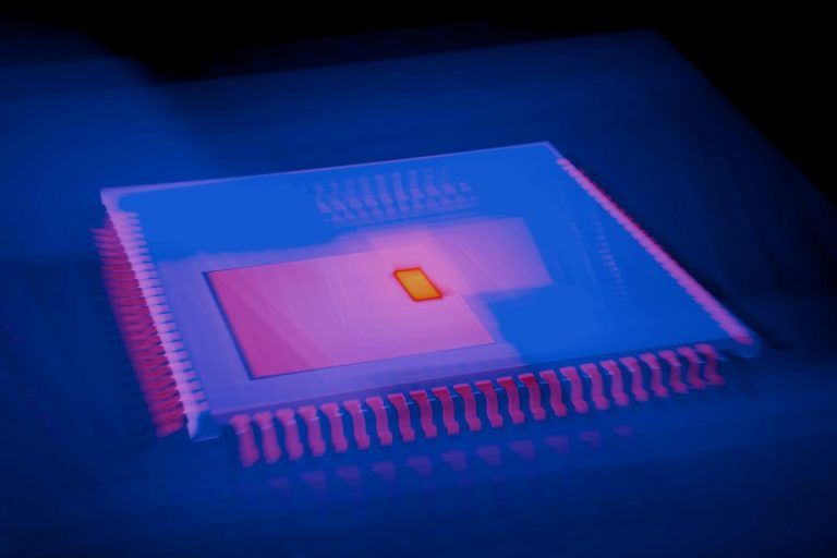 Blurred abstract image of a microchip with heatmap colors highlighting technological innovation.