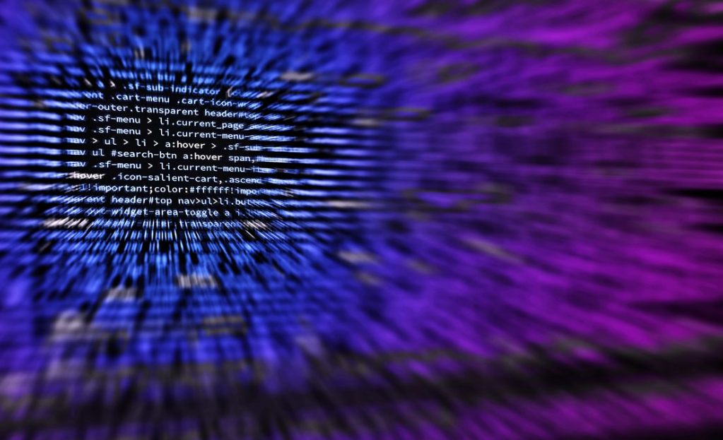 Dynamic abstract background featuring computer code in focus with blurred effect.
