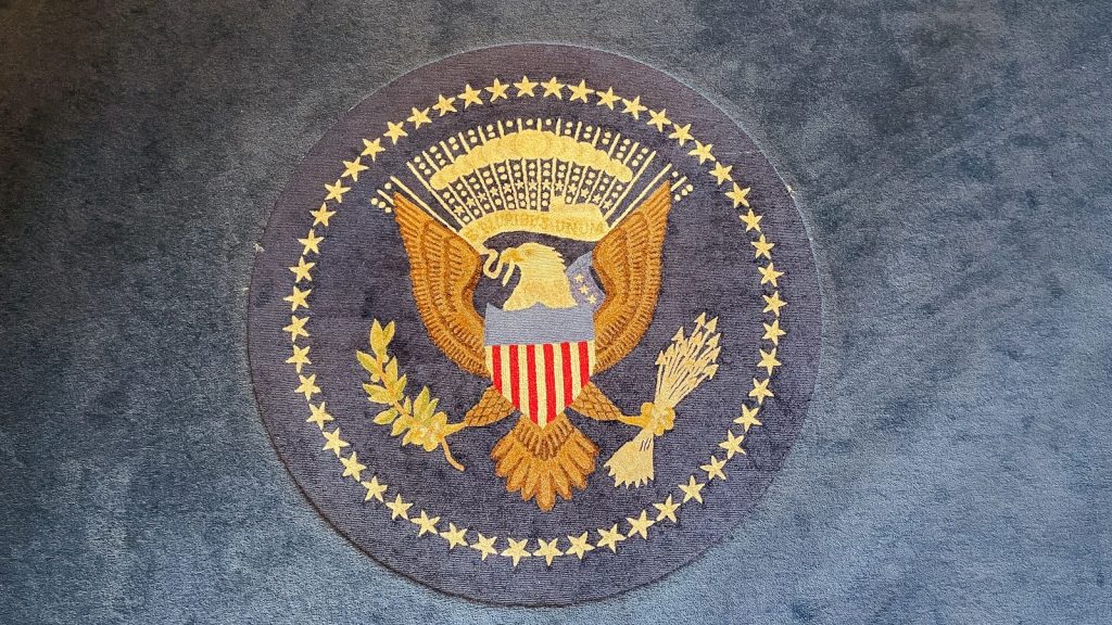 The great seal of the united states on a rug.